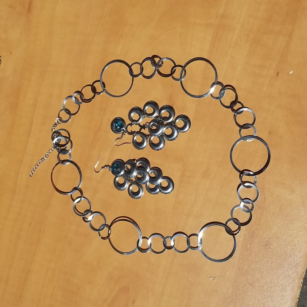 Silver "loopy" matching set of dangling earrings and necklace.